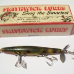 F-100 Devels Horse with the heavy hook hanger and the split ring on the line tie.It has only one spinner. It is the larger floppy spinner like they used on the sinking model. But the sinker had 2 spinners and larger hooks. It is in the color: Frog. It does not have the name stamped on it.The box is the very old 1 1/4" Tall box. It is stamped: F-105 Devels Horse Floater. In the color chart from 1952 the color number 5 was Frog. A year or 2 later it was replaced by Yellow and Silver and Frog was dropped.