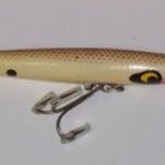 This is a beauty It is stamped DEVEL Horse. It has the split ring on the line tie. It comes in the older two piece box which is 1 1/4" deep and is stamped L-119 DEVELS Horse Floater. It is color # 19 and is what I would call a Brown Scale. I only have one DEVELS color chart where the numbers extend above 16 and that is the chart which I believe is 1962 and it has 22 colors. Color #19 does not show on the chart. It skips from 17 to 22. I believe this lure is from 1956 to 1962..