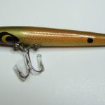 The original number on the Devels Toothpick was ... I-1000.. It then changed to the C-1000.
This is one of the earliest Toothpicks I have seen. It is stamped Devels Toothpick. It is longer than the Toothpicks in later years. The later ones are 2 3/4" long. This one is 3 1/8" long. It is in the color # 8 Shad. The hardware is different than the later ones. It does not have a ball weight. The hooks are different sizes. This is what I call a version 1 Toothpick