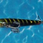 F-600 Prancer - Devils Horse
The wood body is 3" long which is flat on the bottom and it has a rounded spinner on the rear. It also has two hooks. This bait is in color #11 Dragon Fly.