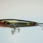 C-1000 Toothpick V2 - Devils -
This is the traditional 2 3/4" long wood body Toothpick. It has no name stamped on it. The hardware is different. It does not has a ball weight. The hooks are different sizes. It is in color #16 Black Shiner. This is what I call a Version 2 Toothpick as it has a fatter body than the previous model.