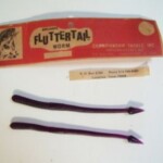 Fluttertail Worm Series.
This is one of the "Fluttertail Worm" series. It is a 7" worm in Grape. I have one in the 10 pack and one in a 20 pack. The body and the tail is unusual on this one. I do not find a picture of this body or tail design in the Smithwick or Championship catalogues. The header card carries both the Smithwick name and the Championship Tackle name. See additional information on this worm under the description for the Lucky "E" Strike Baby Huey Worm listing.