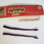 Fluttertail Worm Series.
This is one of the "Fluttertail Worm" series. It is a 7" worm in Grape. I have one in the 10 pack and one in a 20 pack. The body and the tail is unusual on this one. I do not find a picture of this body or tail design in the Smithwick or Championship catalogues. The header card carries both the Smithwick name and the Championship Tackle name. See additional information on this worm under the description for the Lucky "E" Strike Baby Huey Worm listing.