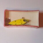 SA-1300 Tail Gater.
This bait is new in a shrink wrap box. It is color #15 Yellow & Green Spots. 1/4 oz.