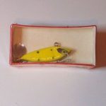 SA-1300 Tail Gater.
This bait is new in a shrink wrap box. It is color #15 Yellow & Green Spots. 1/4 oz.